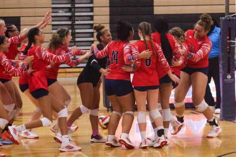 Liberty players celebrate after defeating Legacy in a volleyball game at Legacy High School on ...