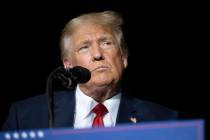 Former President Donald Trump pauses while speaking at a rally at the Minden Tahoe Airport in M ...