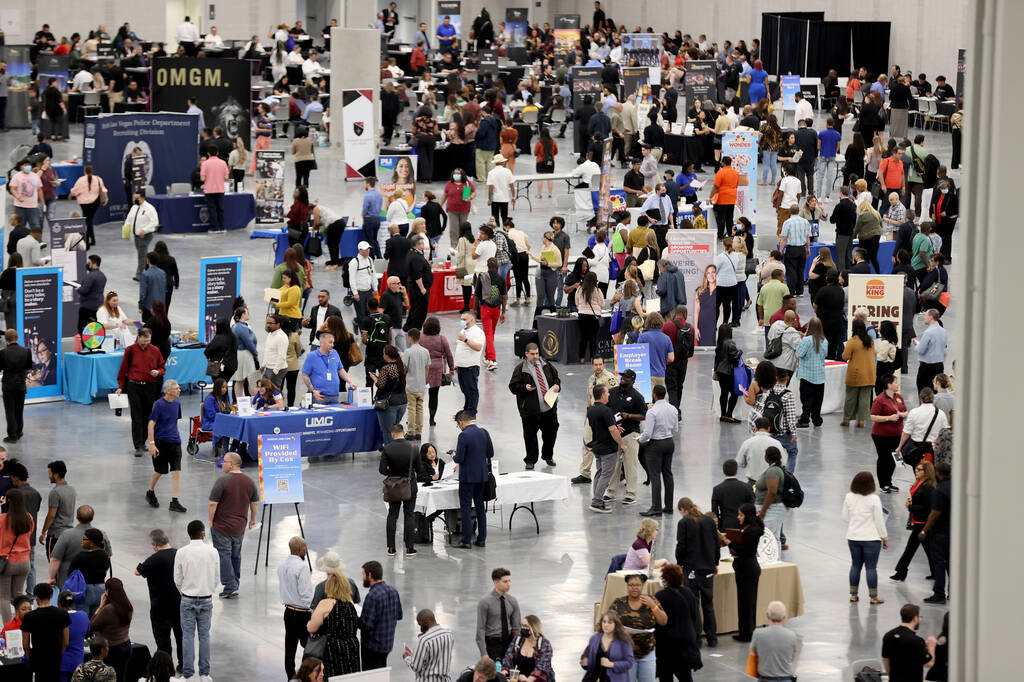 Job seekers visit booths during the Spring Job Fair at the Las Vegas Convention Center Friday, ...
