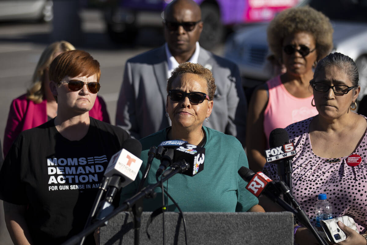 Nevada State Sen. Pat Spearman, center, surrounded by friends, family and supporters, holds a p ...