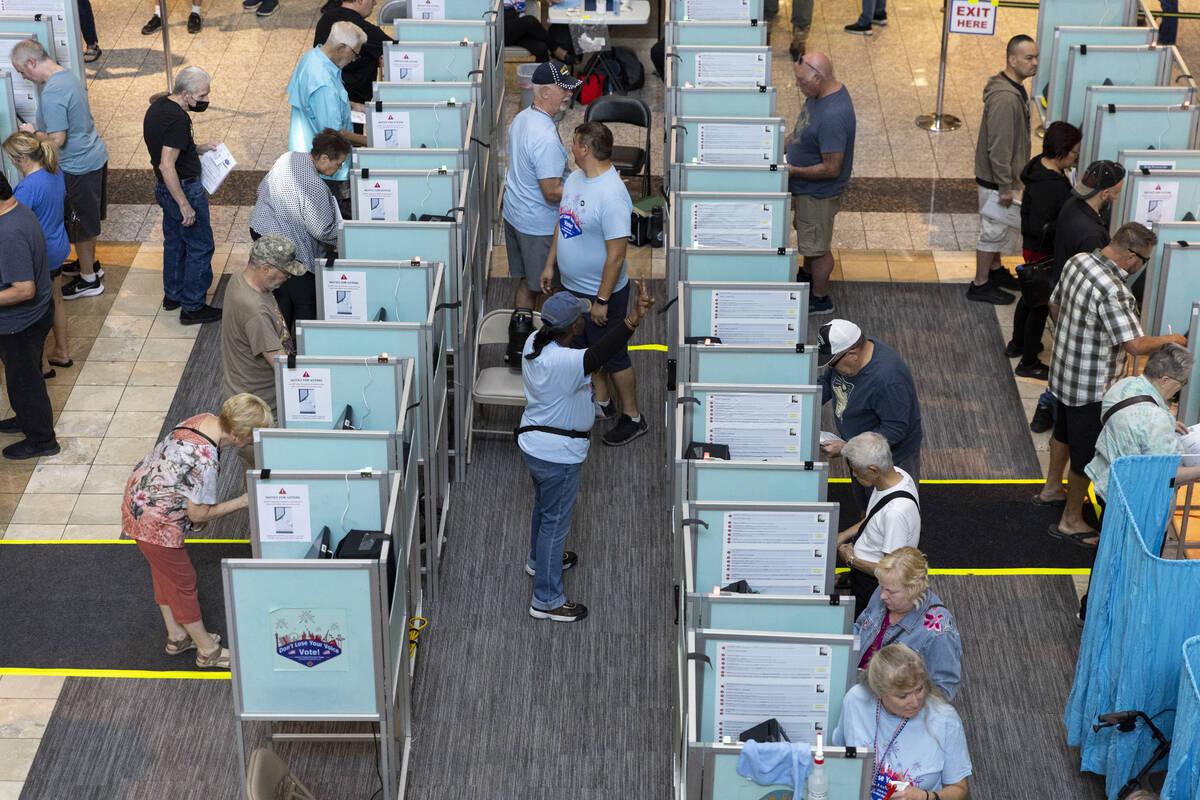 People cast their votes at the polling place inside of the Galleria At Sunset shopping mall in ...