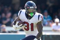 Houston Texans running back Dameon Pierce (31) rushes for yardage during the second half of an ...