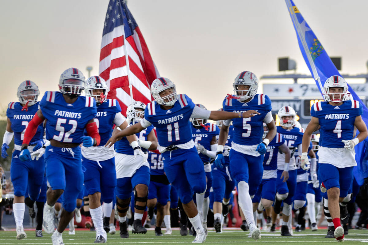 Liberty takes the field before a Class 5A high school football game against Desert Pines at Lib ...