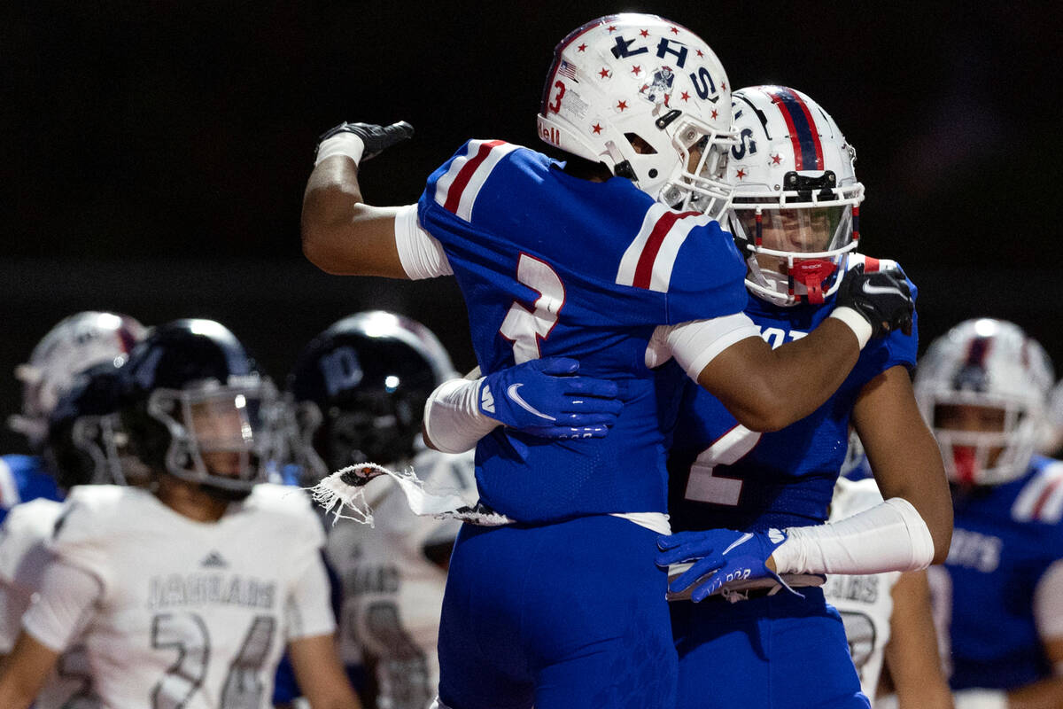 Liberty’s Isaiah Lauofo (3) jumps to congratulate Andre Porter (2) after Porter scored a ...