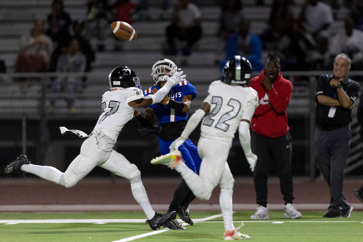 Liberty’s Jayden Robertson (7) is about to catch a long pass while Desert Pines’ ...