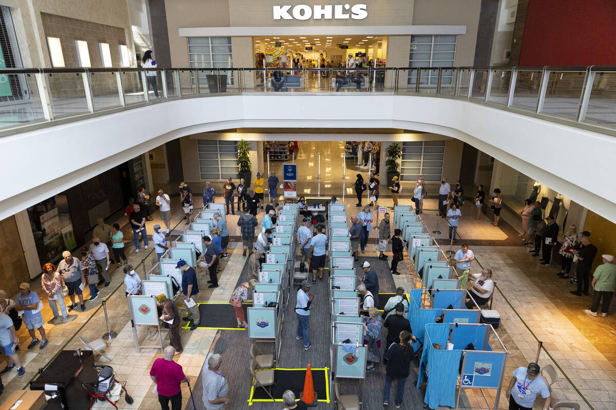 People cast their votes at the polling place inside of the Galleria At Sunset shopping mall in ...
