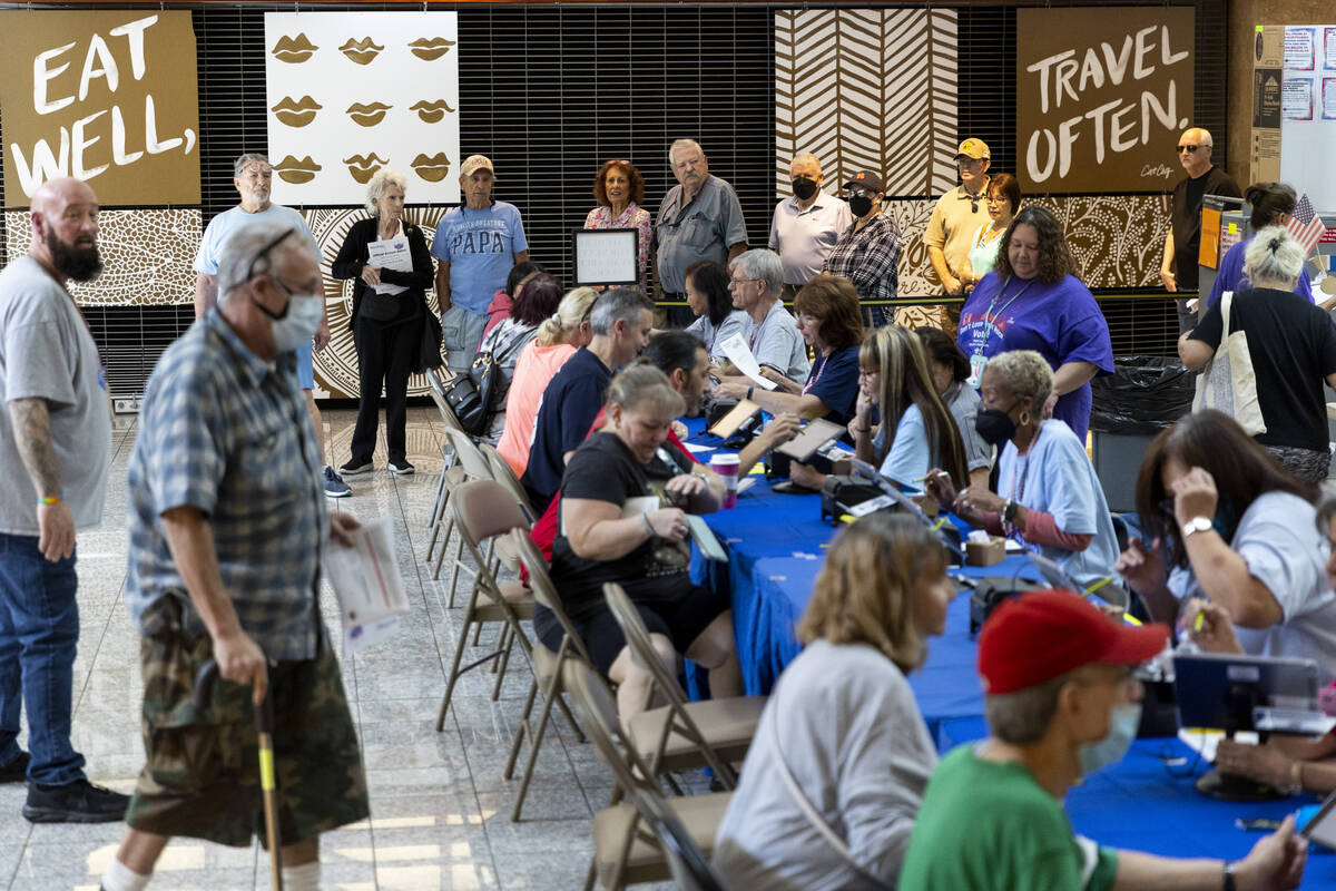 People wait in line to vote at the polling place inside of the Galleria At Sunset shopping mall ...