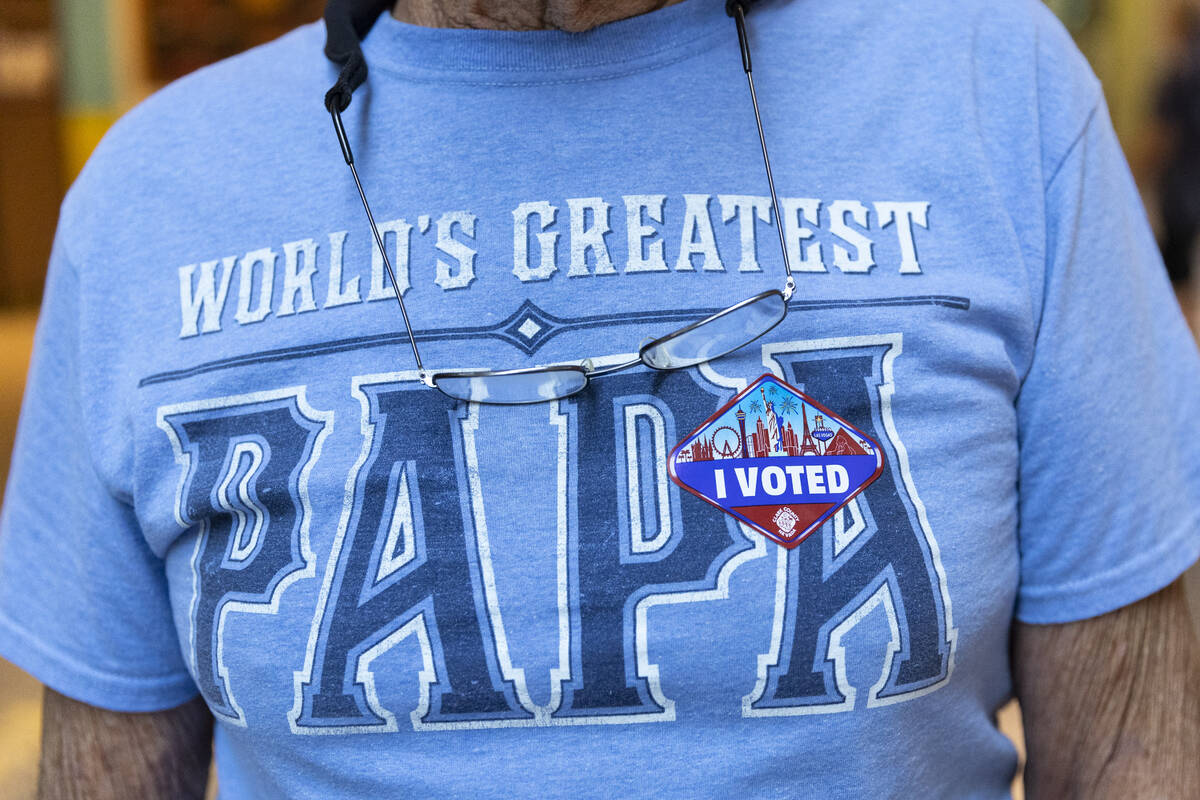 Lewis Janos of Las Vegas, poses with a sticker he received after voting at the polling place in ...