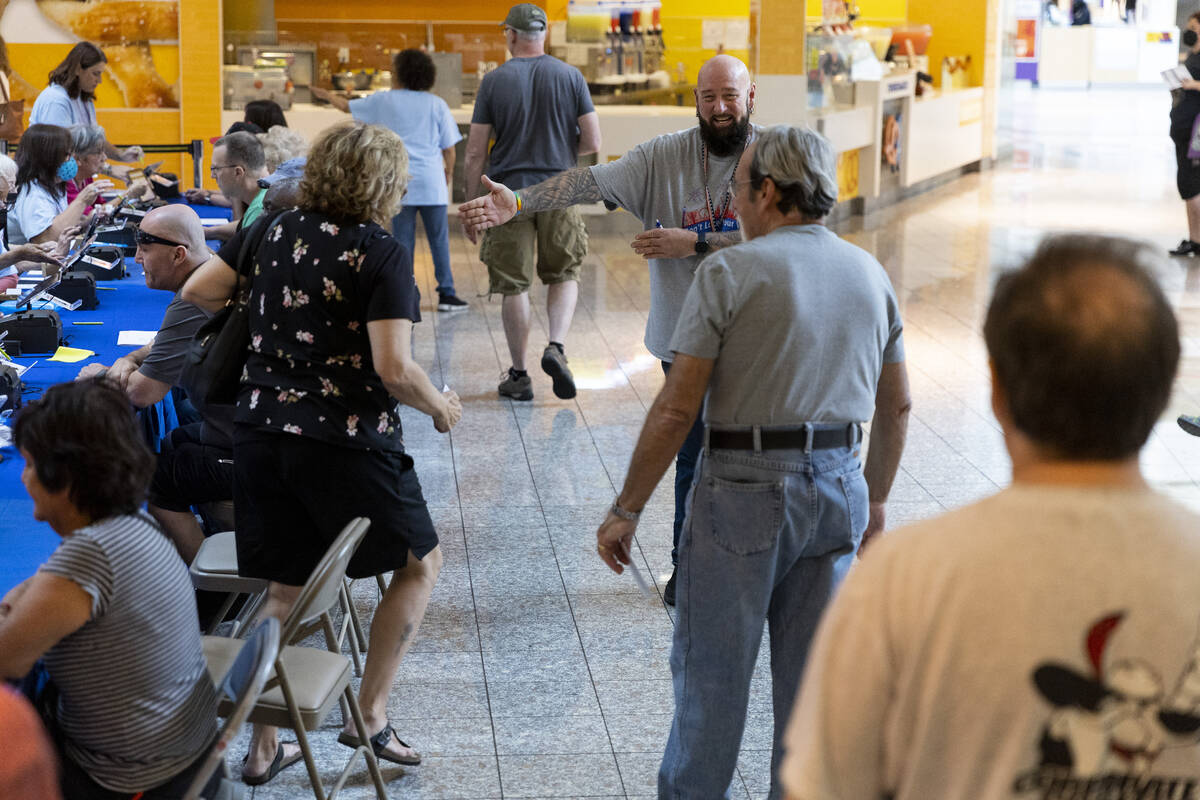 Poll worker Phil Hallond directs people at the polling place inside of the Galleria at Sunset s ...