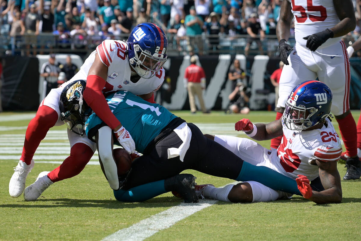 Jacksonville Jaguars running back Travis Etienne Jr. (1) scores past New York Giants safety Jul ...