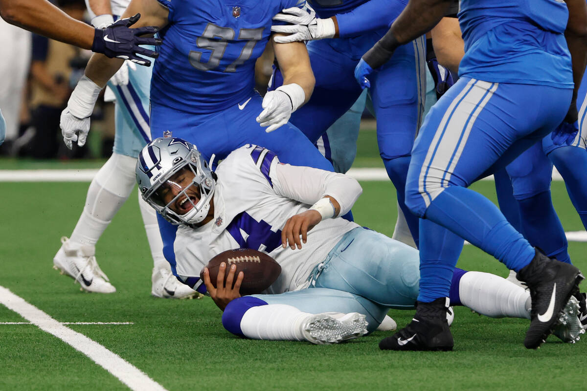 Dallas Cowboys quarterback Dak Prescott (4) is sacked during the first half of an NFL football ...