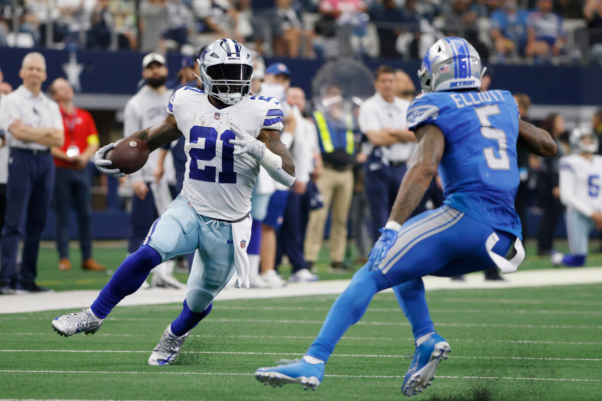 Dallas Cowboys running back Ezekiel Elliott is defended by Detroit Lions safety DeShon Elliott ...