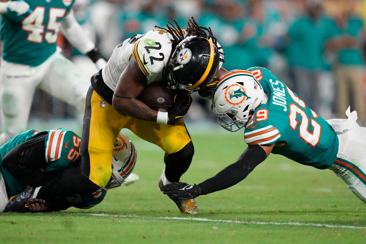 Miami Dolphins linebacker Jerome Baker (55) and safety Brandon Jones (29) tackle Pittsburgh Ste ...