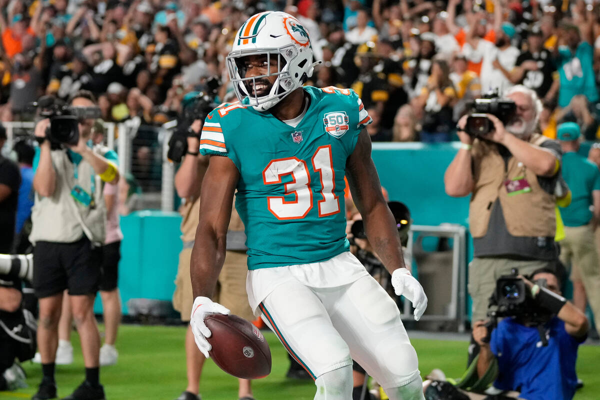 Miami Dolphins running back Raheem Mostert (31) scores a touchdown during the first half of an ...