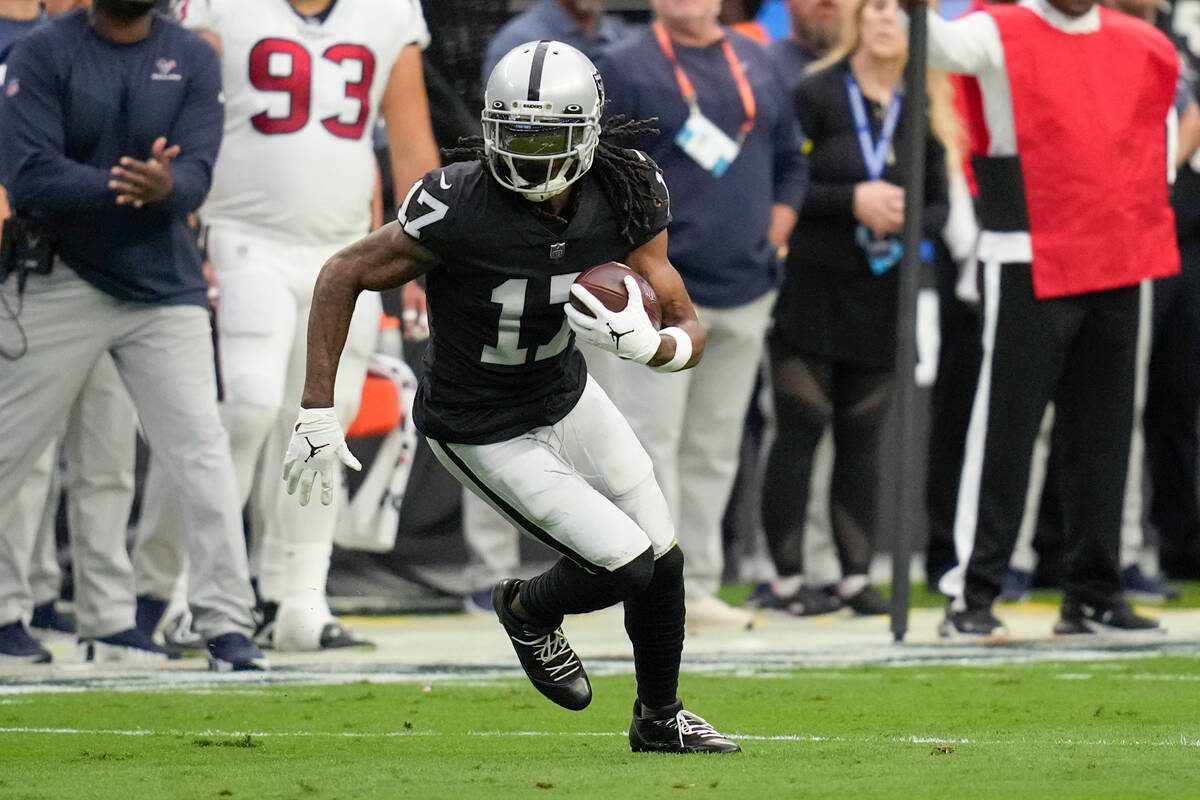 Las Vegas Raiders wide receiver Davante Adams runs with the ball during the first half of an NF ...