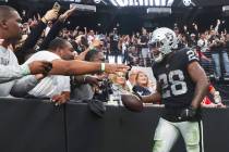 Raiders running back Josh Jacobs (28) celebrates his touchdown with fans during the second half ...