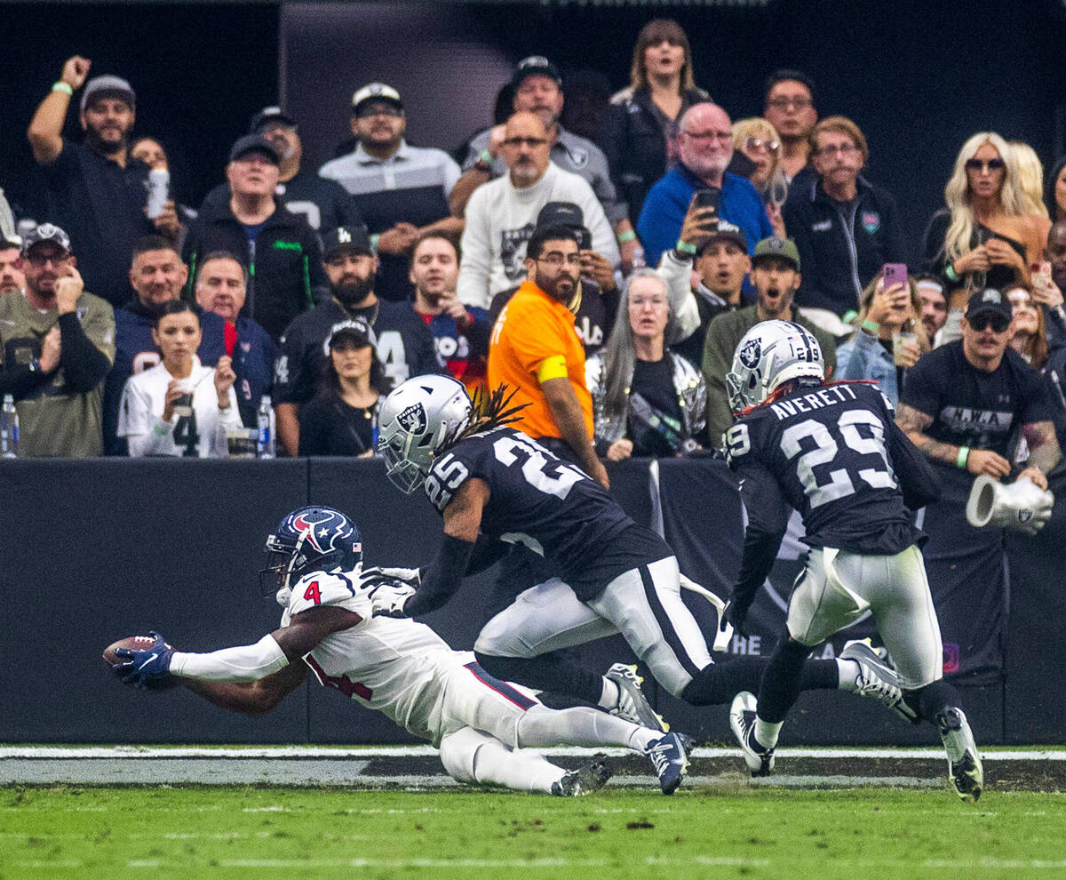 Houston Texans wide receiver Phillip Dorsett (4) dives for a touchdown catch as Raiders safety ...