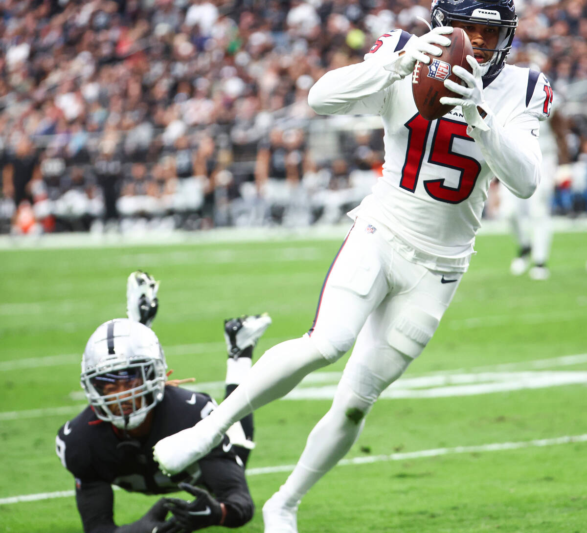 Houston Texans wide receiver Chris Moore (15) leaps to make a touchdown past Raiders cornerback ...