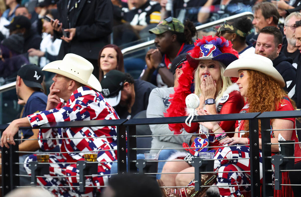 Houston Texans fans react as their team trails the Raiders during the second half of an NFL gam ...