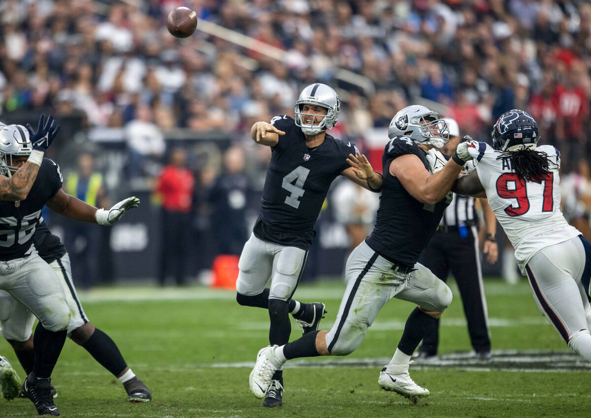 Raiders quarterback Derek Carr (4) makes a throw against the Houston Texans defense during the ...
