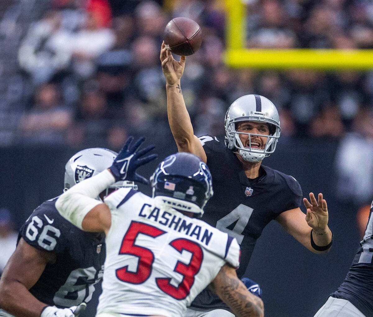 Raiders quarterback Derek Carr (4) passes over Houston Texans linebacker Blake Cashman (53) dur ...