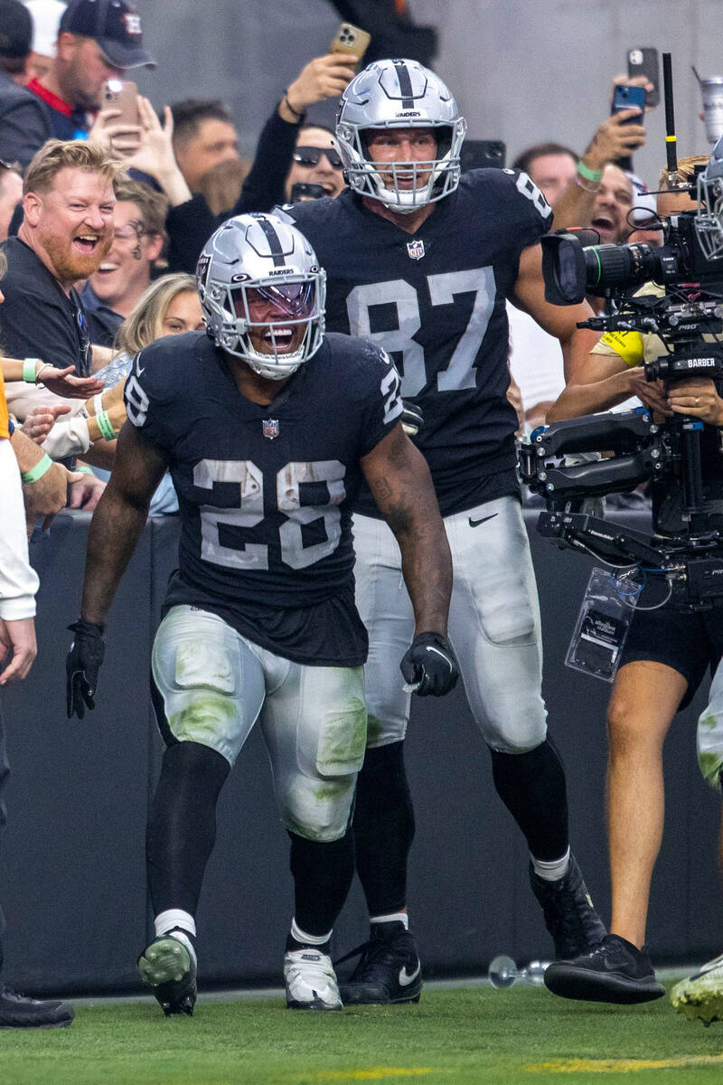 Raiders running back Josh Jacobs (28) celebrates his touchdown score with tight end Foster More ...