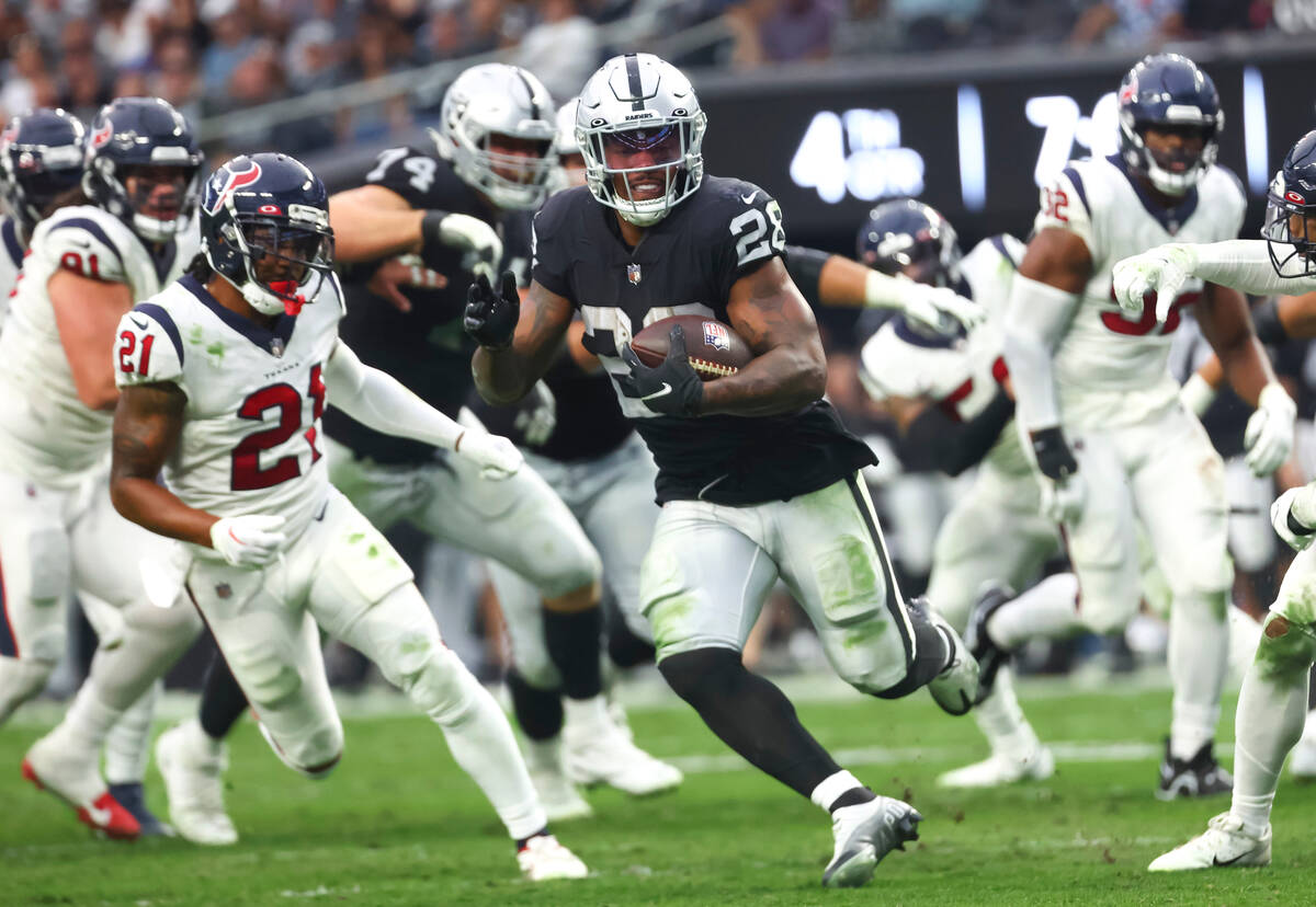 Raiders running back Josh Jacobs (28) runs the ball against the Houston Texans during the secon ...