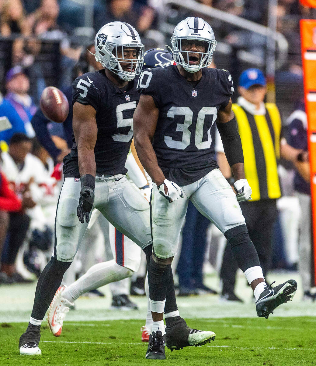 Raiders safety Duron Harmon (30) and linebacker Divine Deablo (5) are pumped after a late stop ...