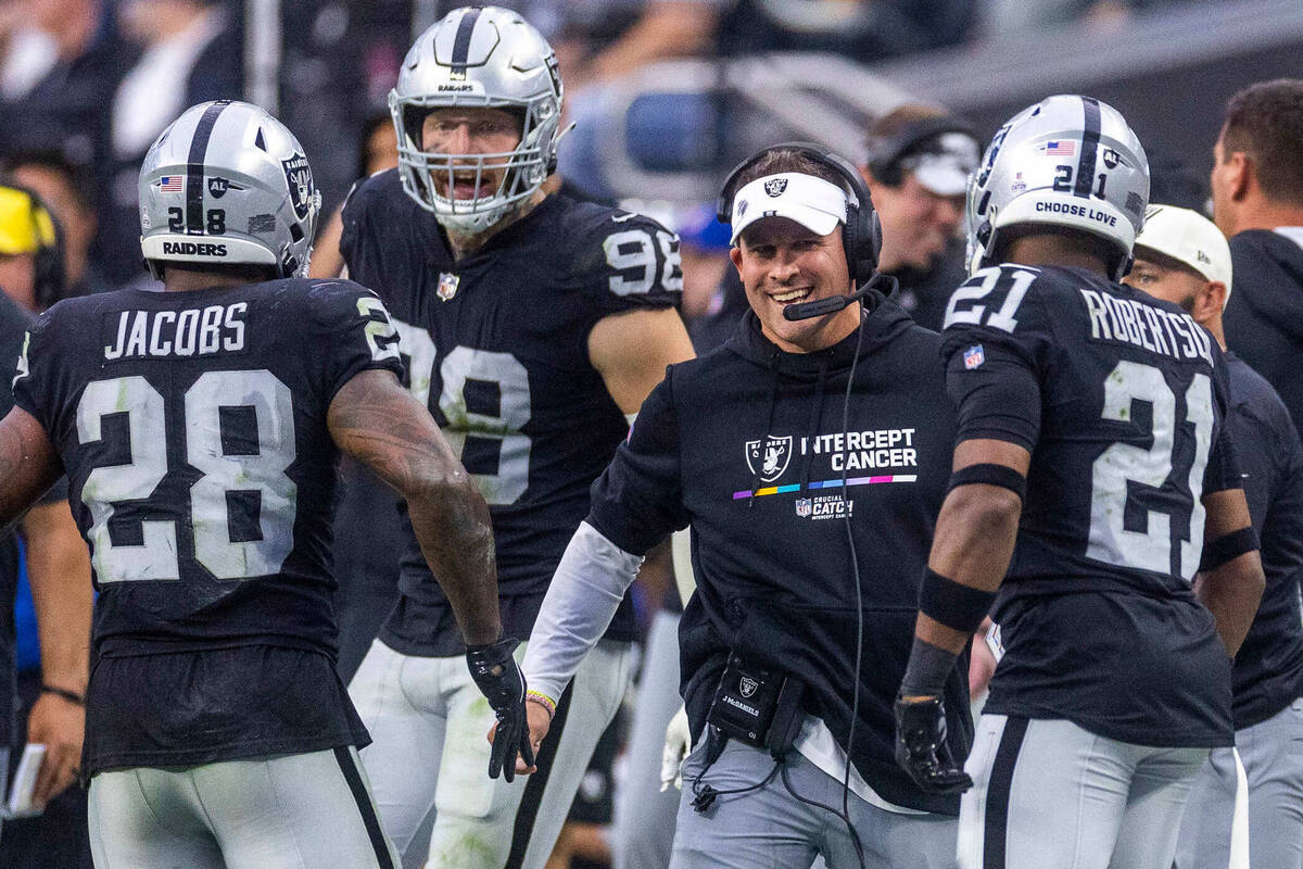 Raiders running back Josh Jacobs (28) runs off after a third touchdown to the delight of Head C ...
