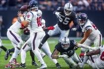 Houston Texans quarterback Davis Mills (10) looks not pass under pressure by Raiders defensive ...