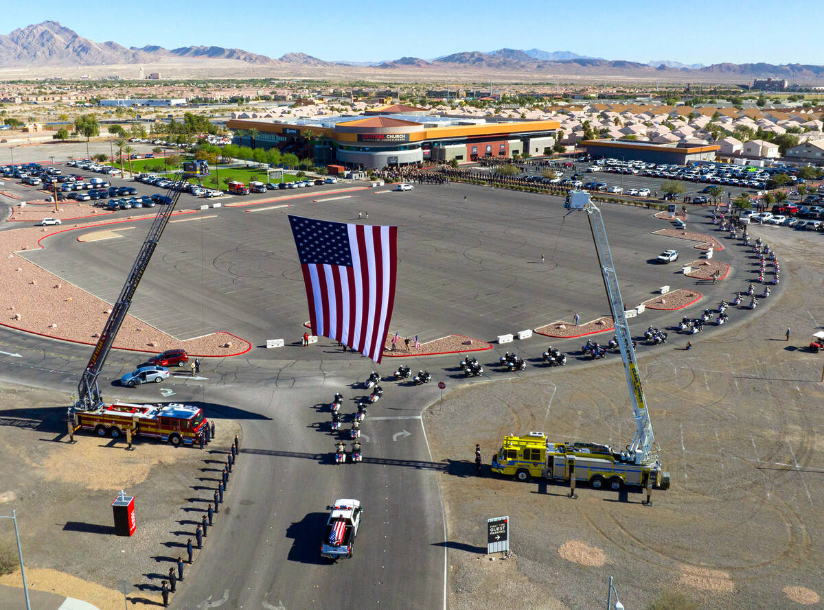 A hearse carrying the casket of fallen Metropolitan Police Officer Truong Thai arrives at Centr ...