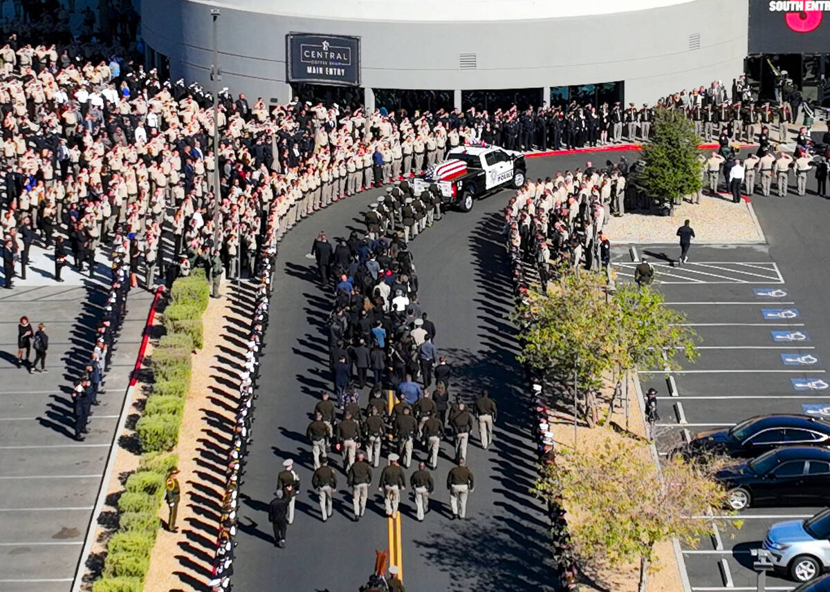 Las Vegas police officers salute as the hearse carrying the casket of fallen Metropolitan Polic ...