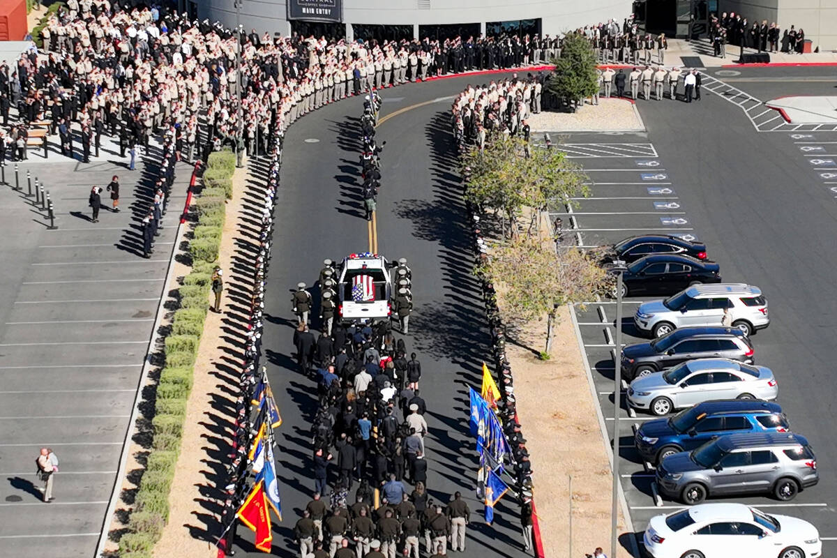Metro police officers salute the hearse carrying the casket of fallen Metropolitan Police Offic ...