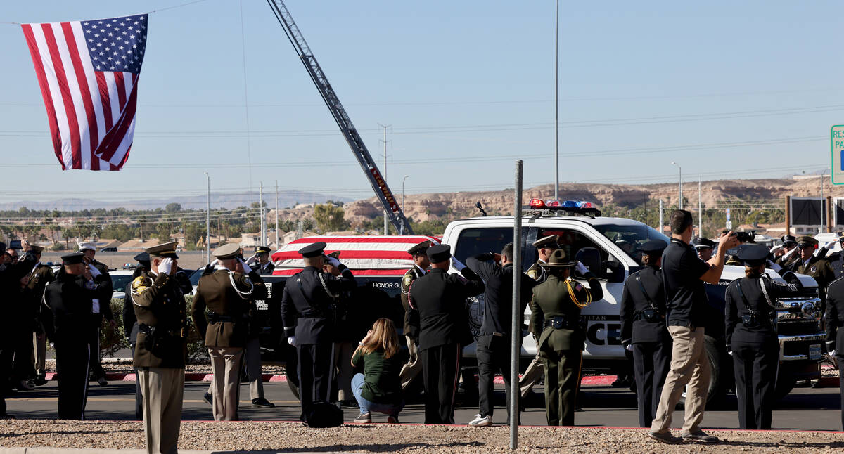 Honor guard officers salute as the procession for fallen Las Vegas police officer Truong Thai a ...