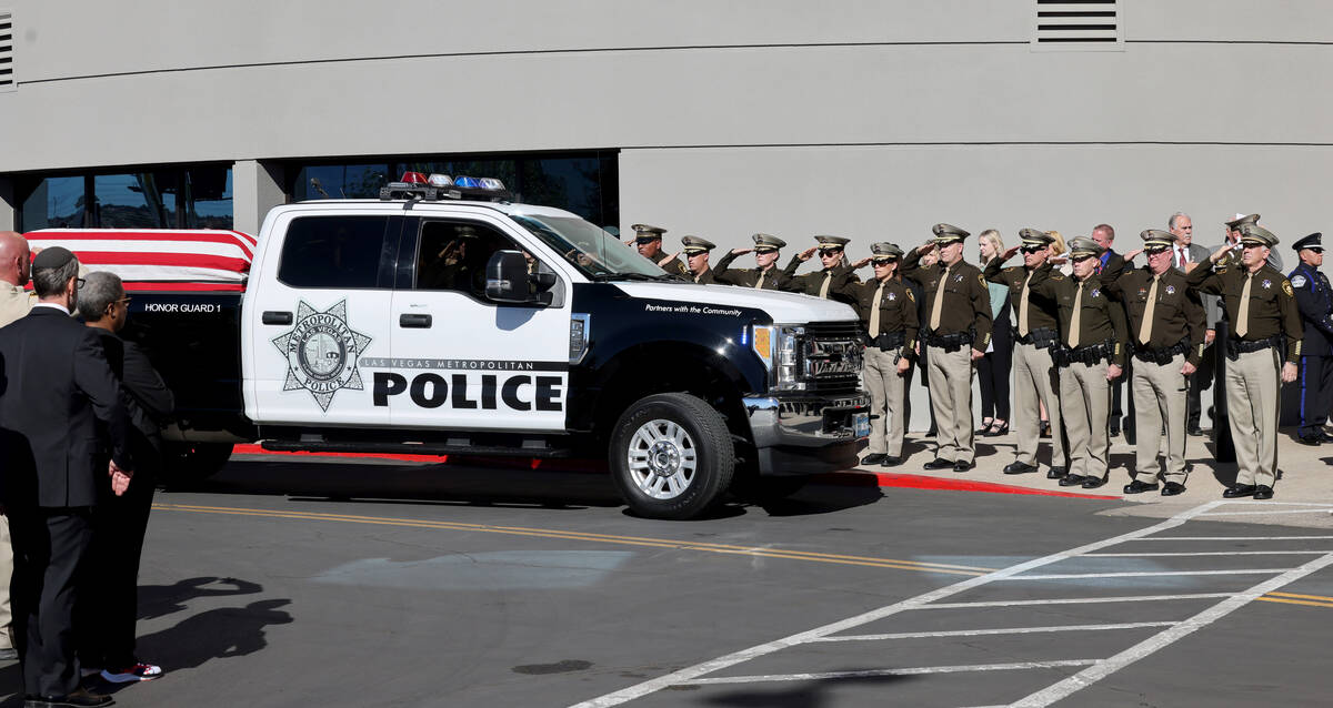 Officers, including Clark County Sheriff Joe Lombardo, salute as the procession for fallen Las ...