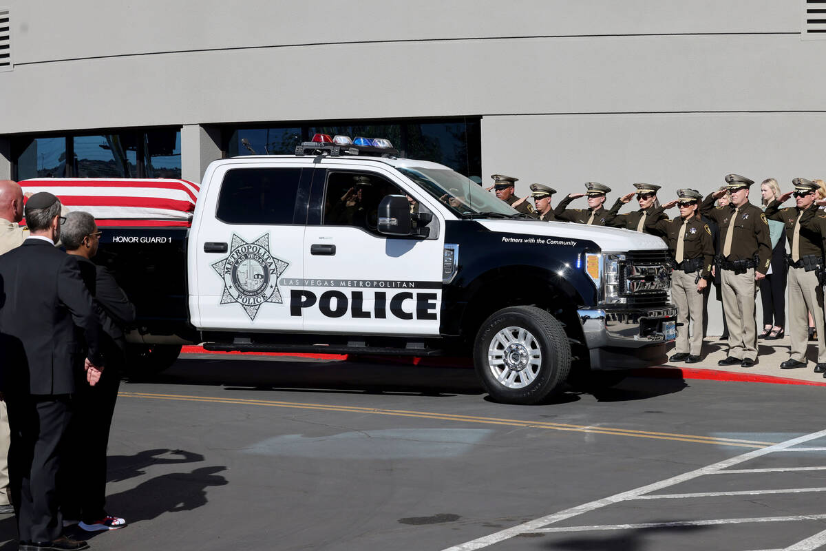 Officers, including Clark County Sheriff Joe Lombardo, salute as the procession for fallen Las ...