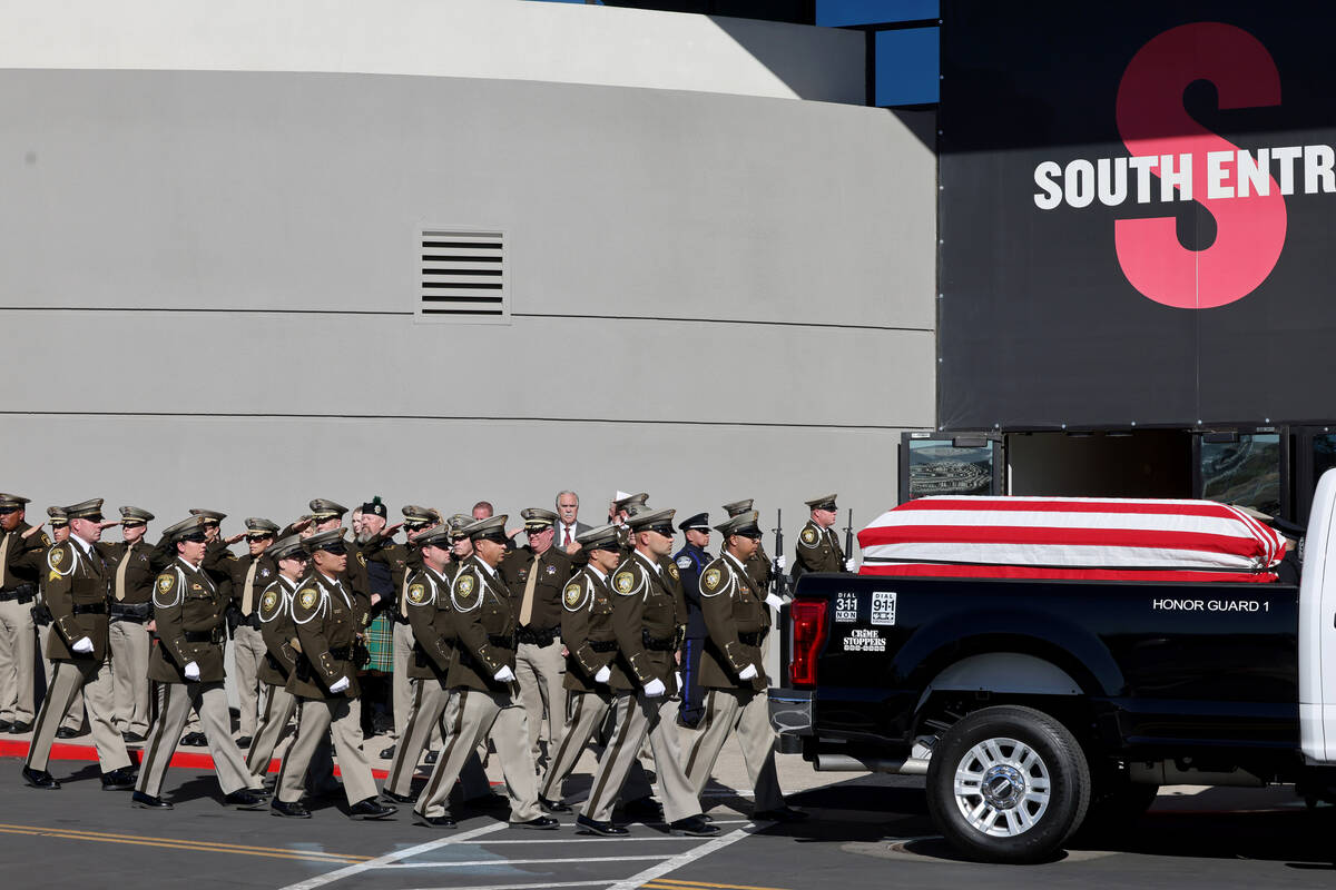 Officers salute as the procession for fallen Las Vegas police officer Truong Thai arrives at Ce ...