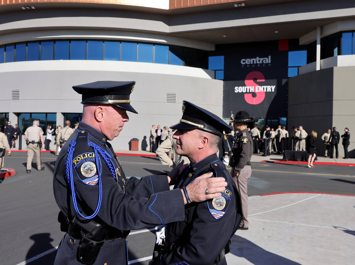 Clark County School District Police Lt. Bryan Zink, left, and A. Gaspardi, arrive for funeral s ...