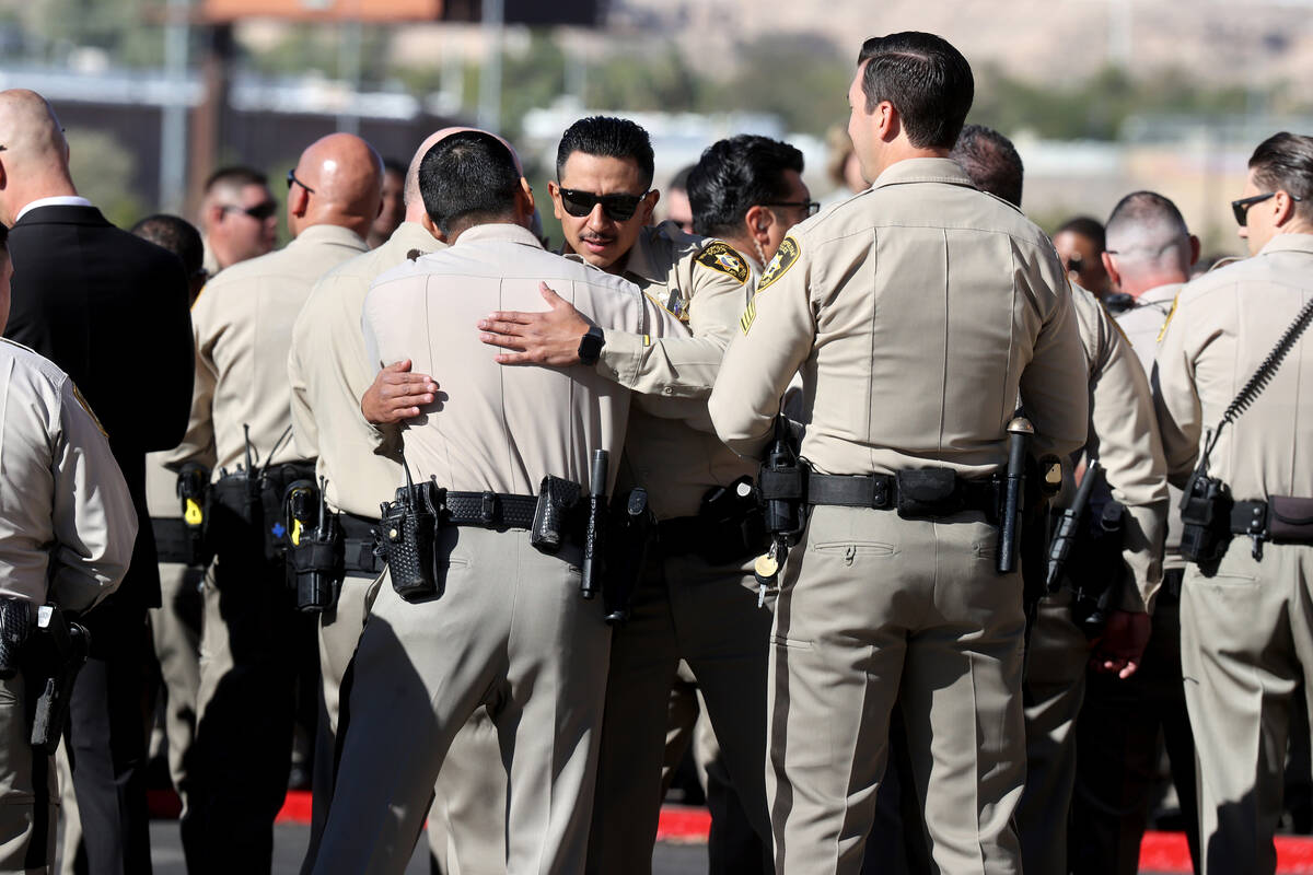 Officers embrace as they arrive for the services of fallen Las Vegas police officer Truong Thai ...