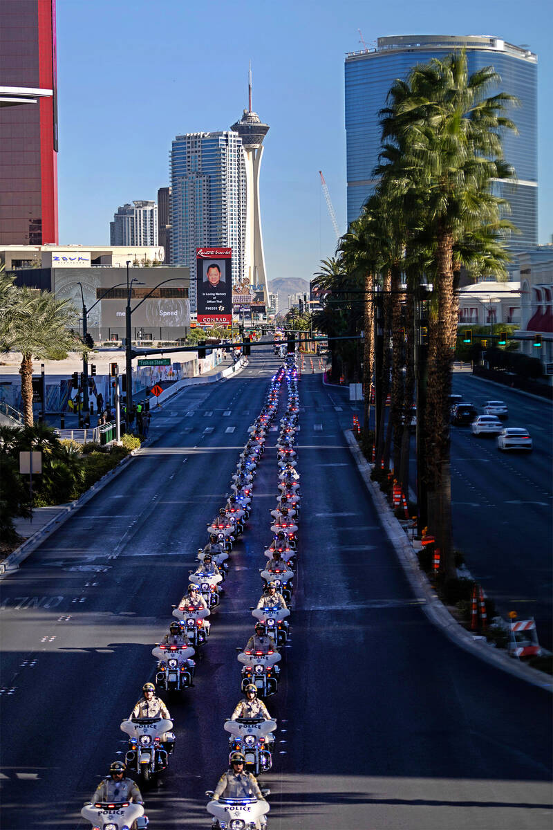 A procession for the late Las Vegas police officer Truong Thai moves down Las Vegas Boulevard t ...