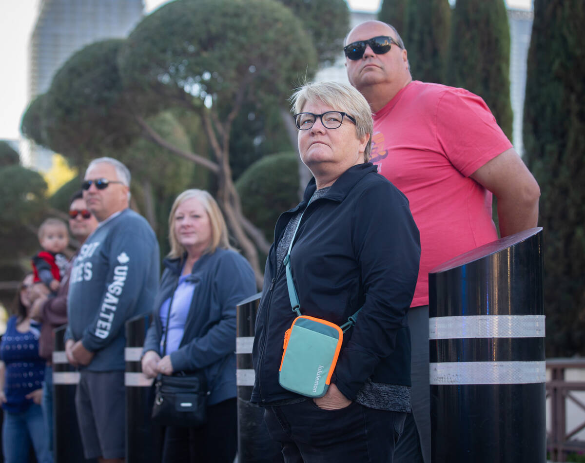 From right, Tammy Gilmour, 57, and Drew Gilmour, 61, watch as a funeral procession is held on t ...