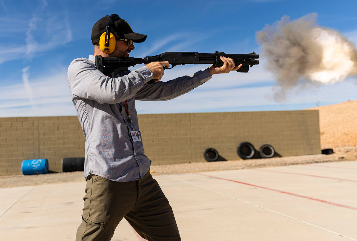 Review-Journal reporter Brett Clarkson fires a Remington 870 shotgun during a range day held by ...
