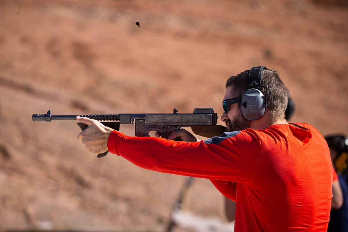 FBI firearms instructor and special agent Ian Dickenson fires an Auto-Ordnance Thompson M1 duri ...