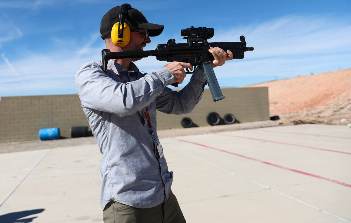 Review-Journal reporter Brett Clarkson fires a Heckler & Koch MP5 during a range day held b ...