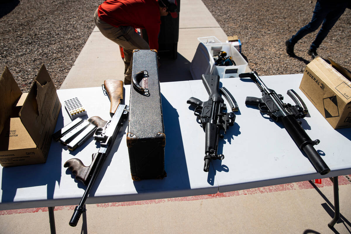 Automatic rifles, an Auto-Ordnance Thompson M1, or Tommy Gun, left, and a pair of Heckler & ...