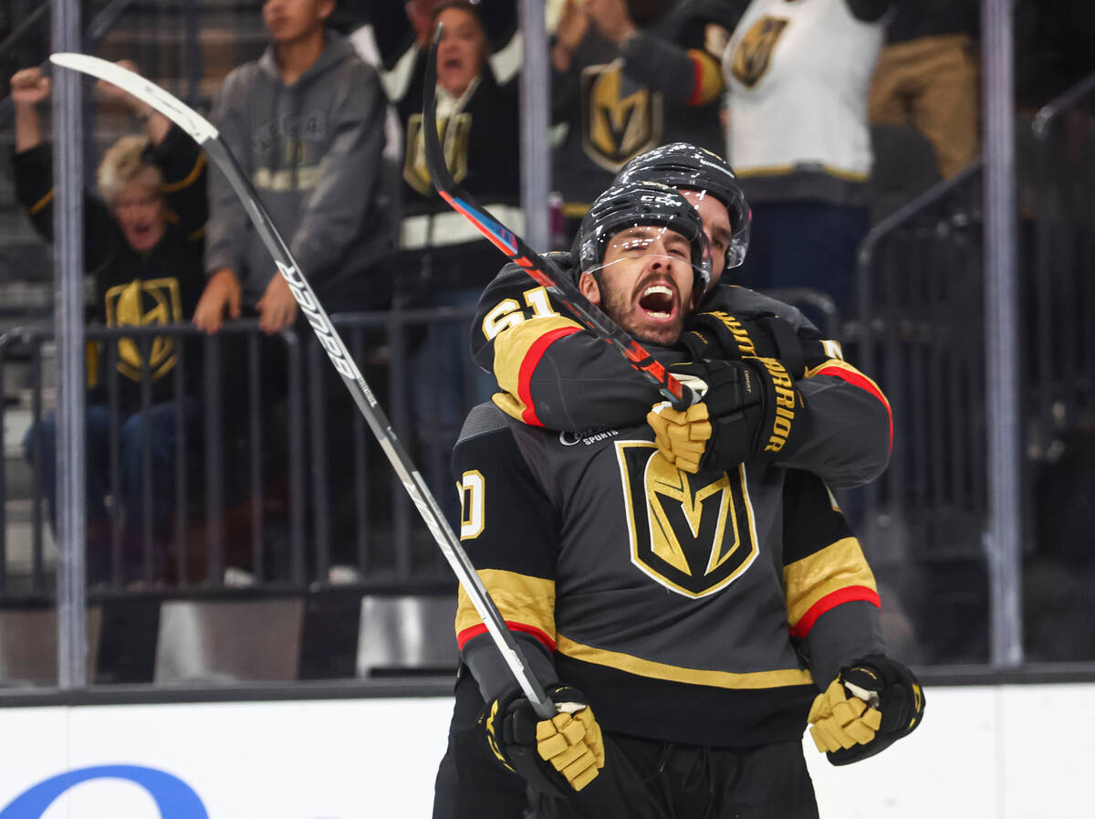 Golden Knights center Chandler Stephenson, in front, celebrates his goal with right wing Mark S ...