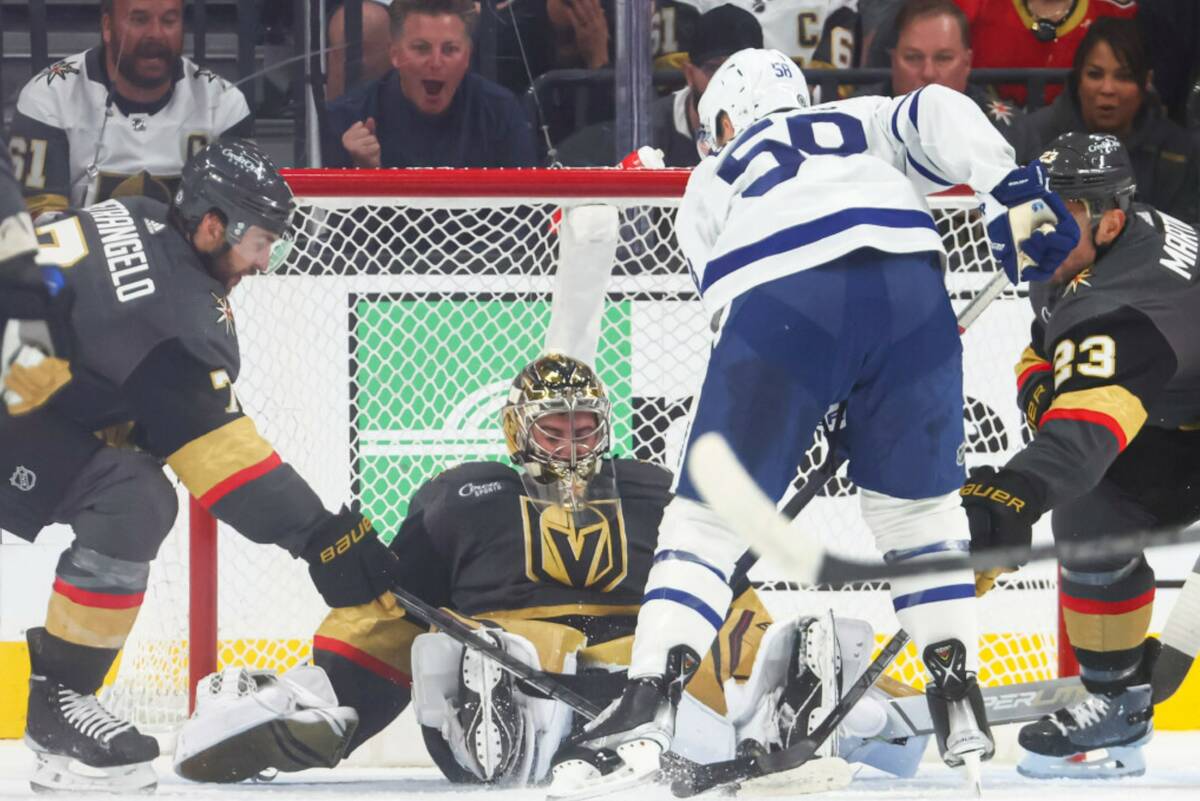 Vegas Golden Knights goaltender Logan Thompson (36) stops the puck in front of Toronto Maple Le ...