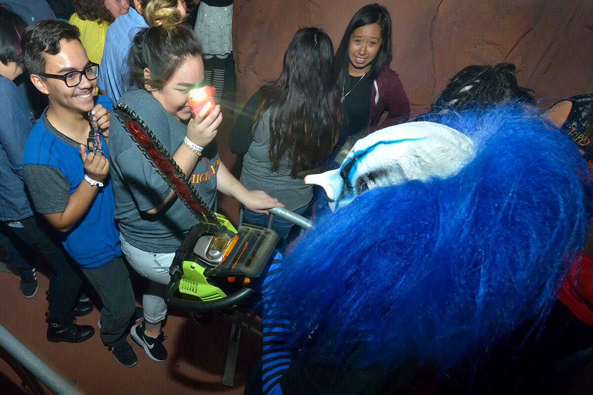 Gianni Mydlach, as Notorious the Clown, foreground right, entertains patrons as they wait in li ...