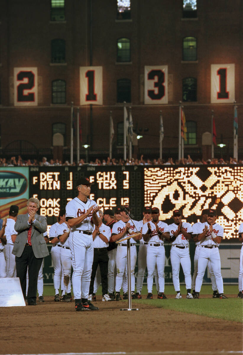 Baltimore Orioles shortstop Cal Ripken Jr. stands with his teammates in front of the sign readi ...