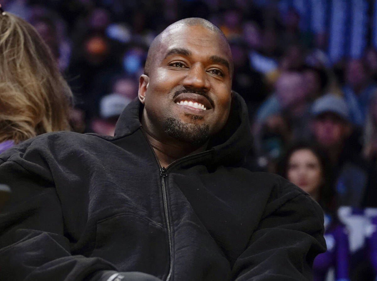 Kanye West watches the first half of an NBA basketball game between the Washington Wizards and ...